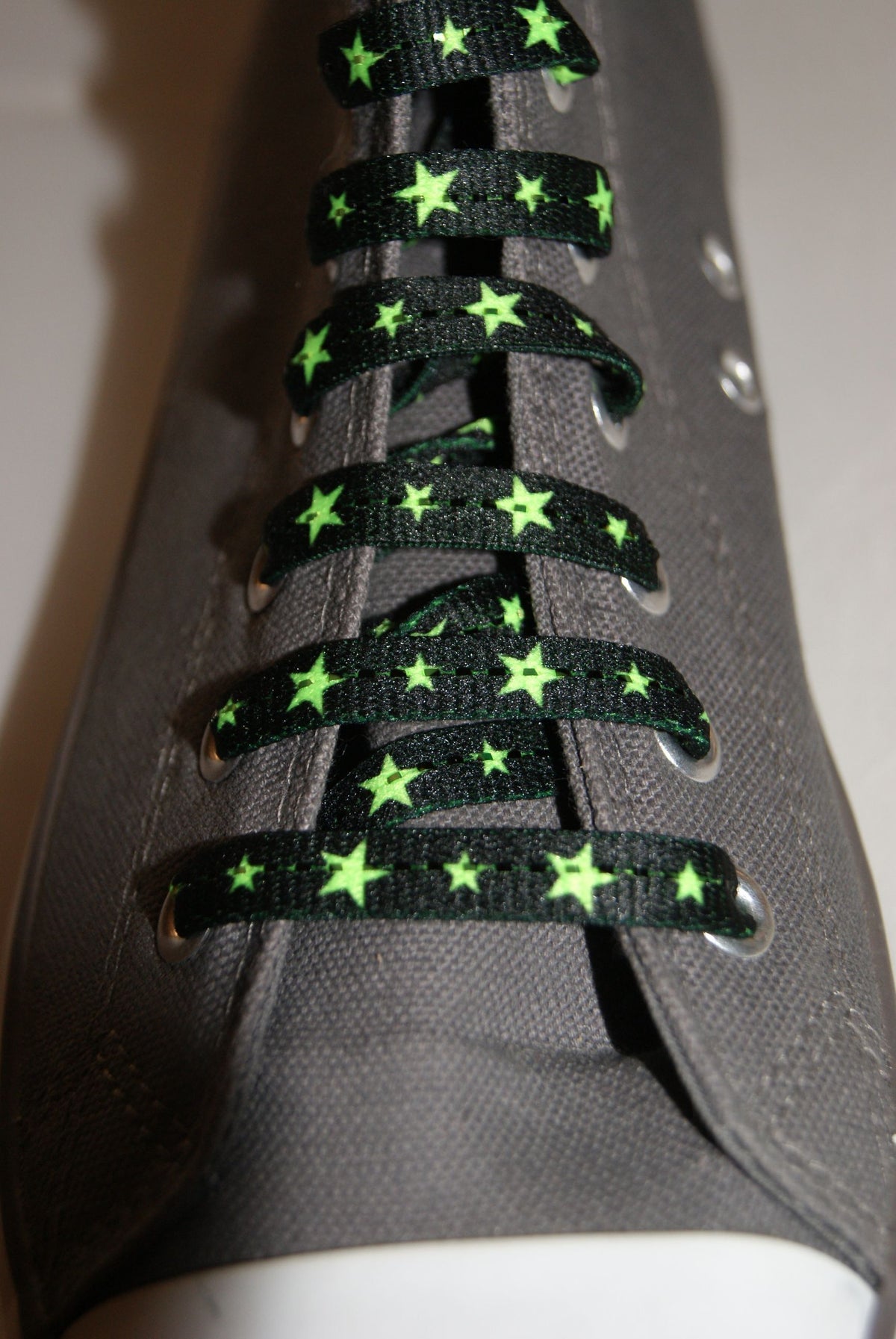 Black laces and neon green stars
