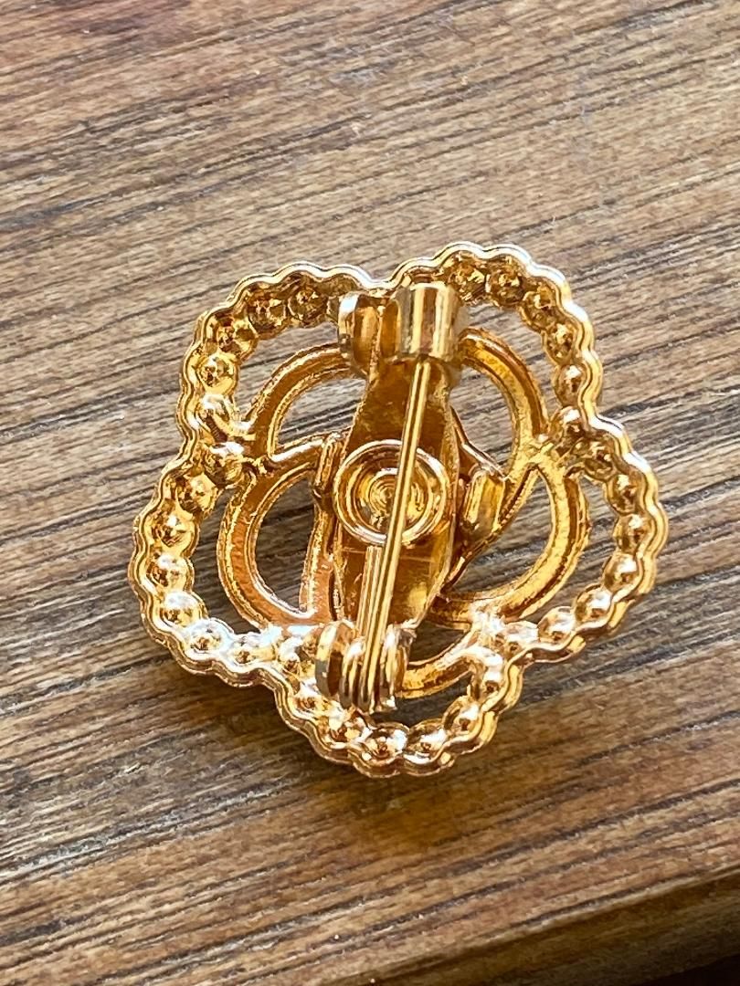 Retro-style floral and rhinestone brooch