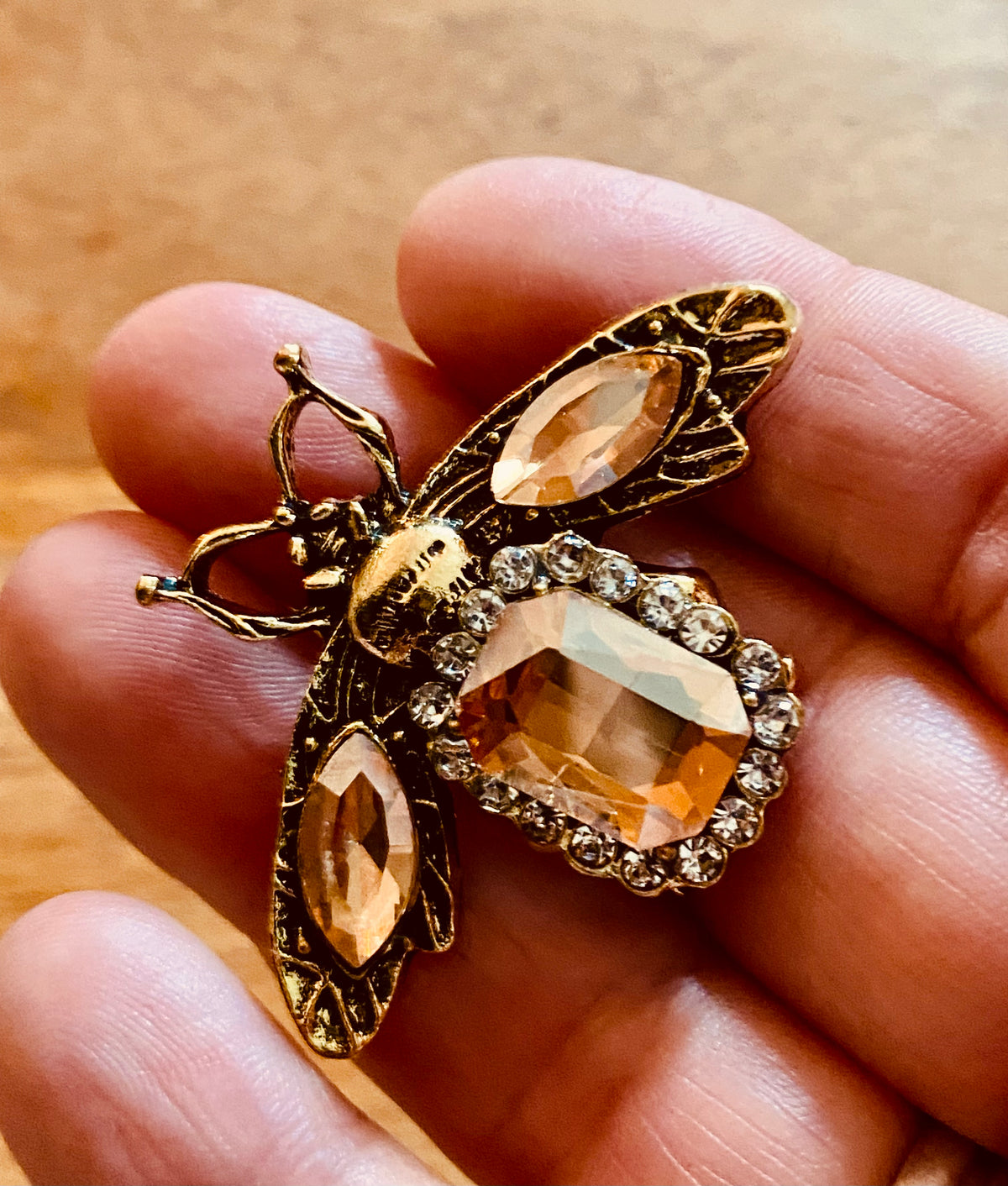 Golden bee brooch with orange rhinestones
