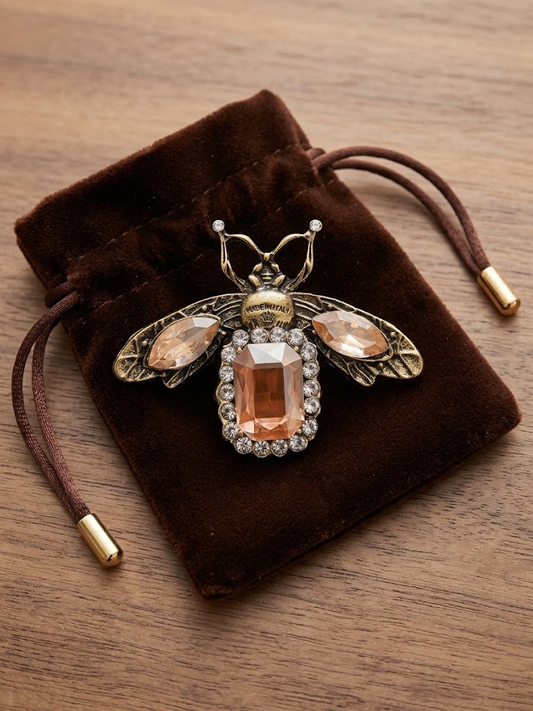 Broche abeille dorée à strass orangés