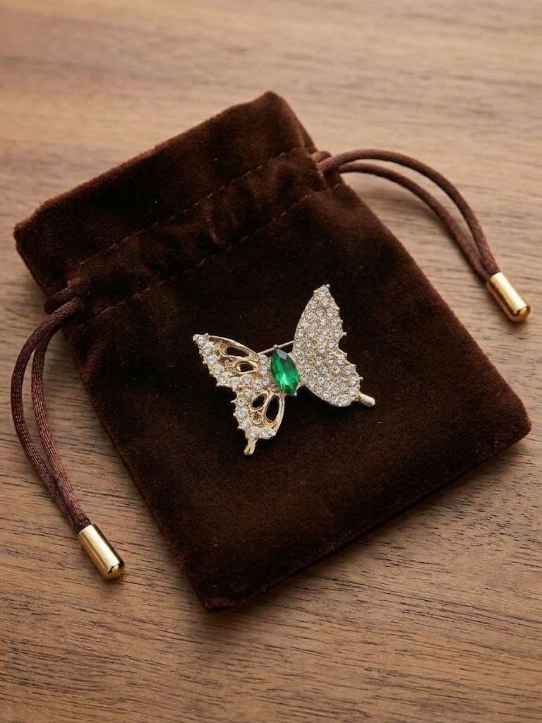 Small gold rhinestone butterfly brooch, green center